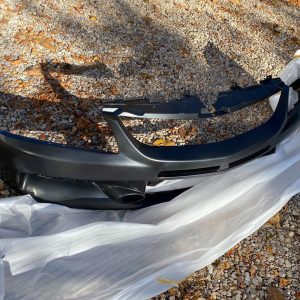 Buy Mitsubishi OEM Front Bumper Evo 9 6400B000 online, Shop the genuine black urethane bumper cover for the 2006 Mitsubishi Evolution IX.